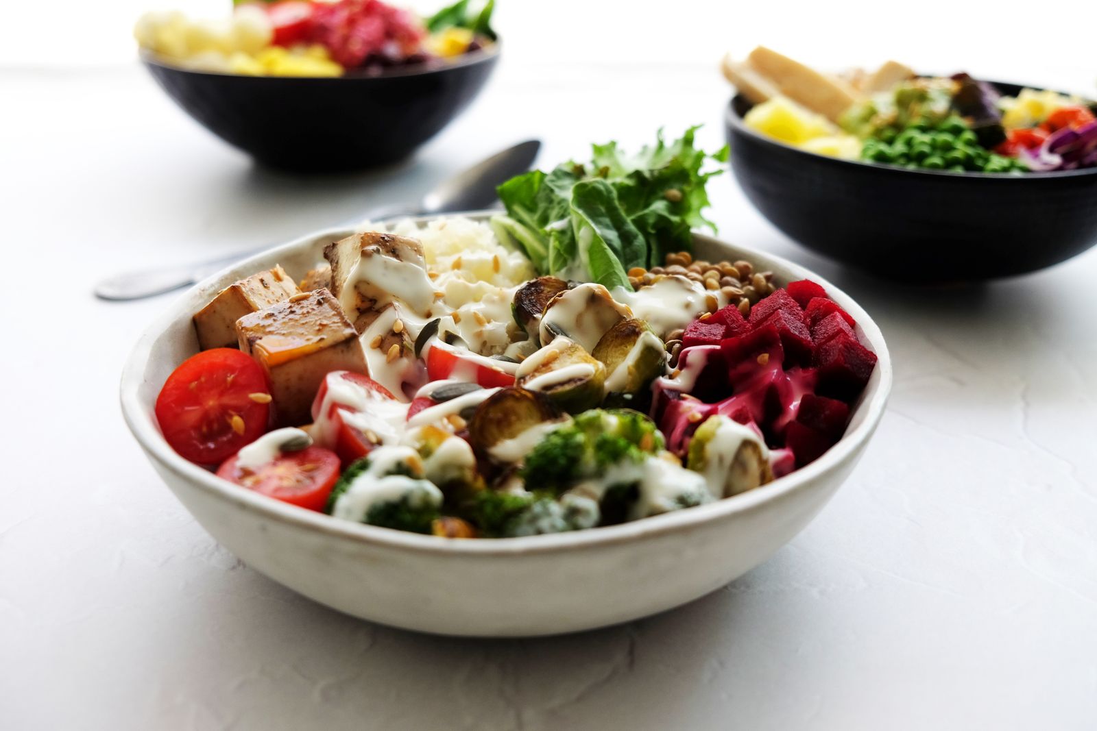 Colorful plant-based bowls filled with fresh vegetables and grains