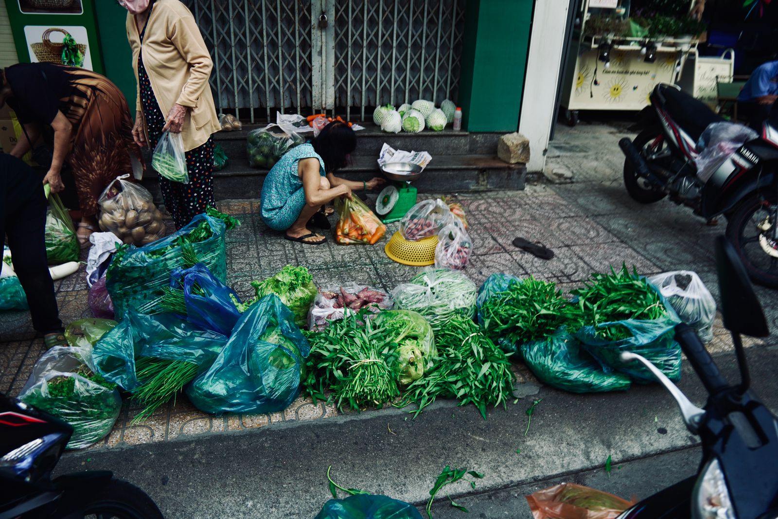 A street market stall piled with fresh vegetables